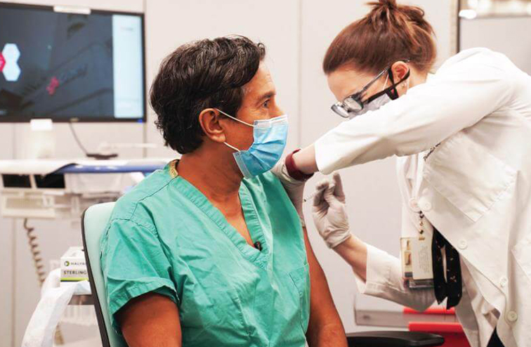 Dr. Gupta recieving COVID-19 vaccine