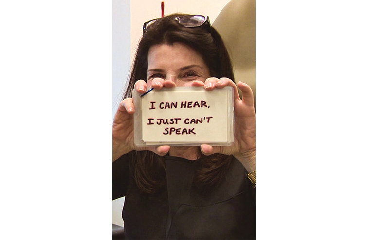 Nanci Ryder holding up a message