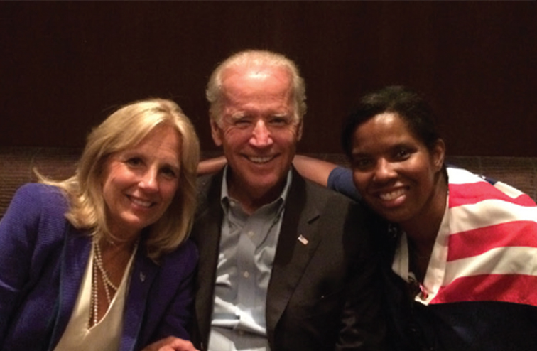 Scurry draped in an American flag, sitting with Jill and Joe Biden in 2015.