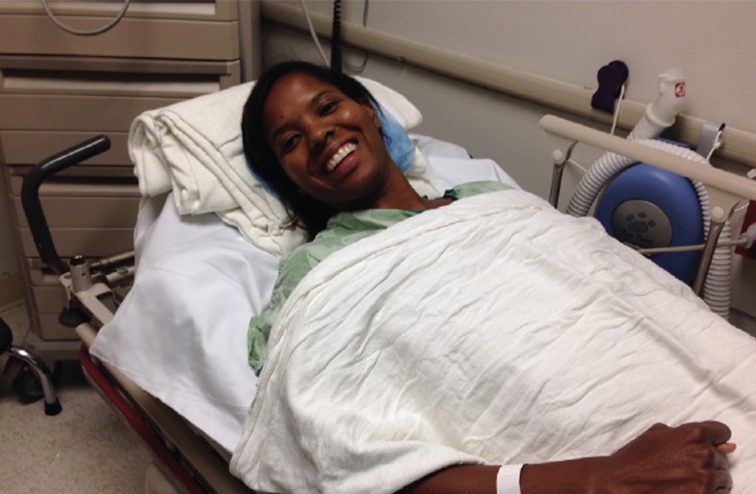 A smiling Scurry lies in her hospital bed after her surgery in 2013.