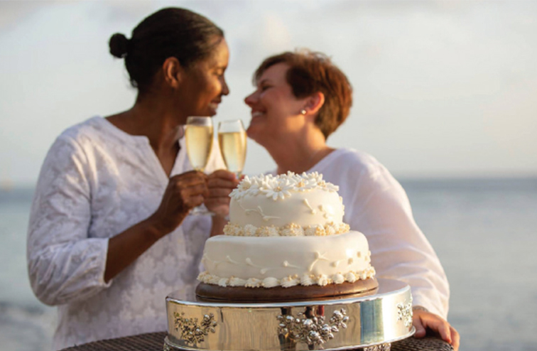 Scurry and her wife clink champagne glasses at their wedding in 2018.