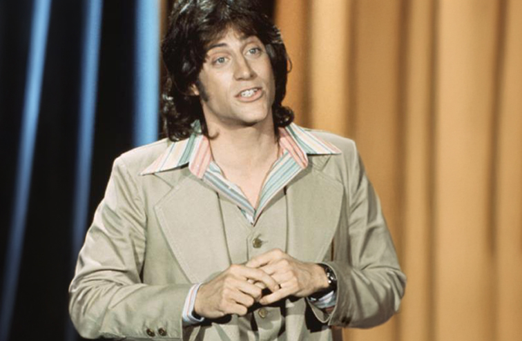 A long haired Lewis performing on The Tonight Show in 1977.