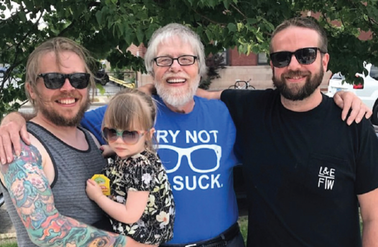 Dan Jacobs smiling with his brother, niece, and his father