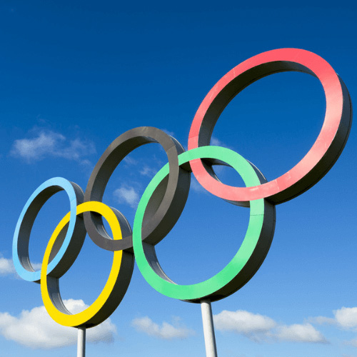 Image of the Olympic rings against a blue sky background