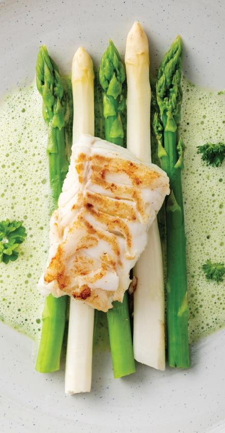 Fish served on top of asparagus